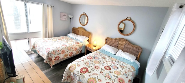 bedroom with dark wood-style floors