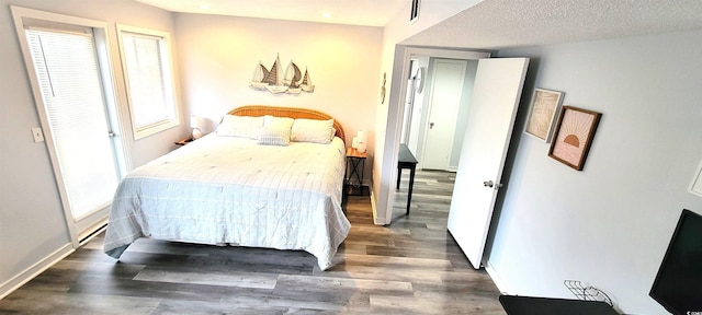 bedroom featuring baseboards, visible vents, and dark wood-type flooring