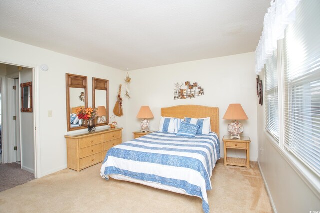 bedroom featuring light colored carpet