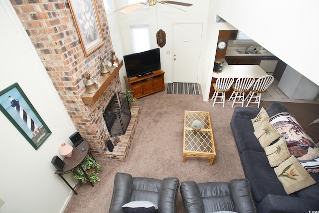 living room with sink, ceiling fan, and carpet