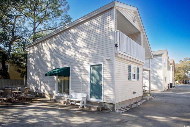 back of house featuring a balcony