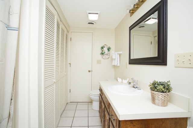 bathroom featuring vanity, toilet, and tile patterned flooring