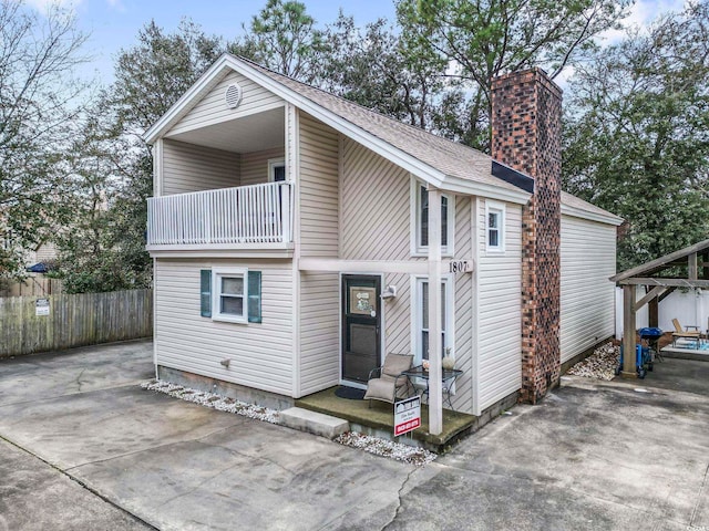 rear view of property with a balcony