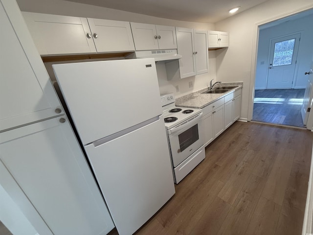 kitchen with white appliances, white cabinets, dark wood-type flooring, ventilation hood, and a sink