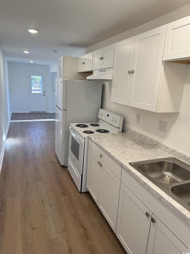 kitchen with white appliances, dark wood finished floors, white cabinets, and under cabinet range hood