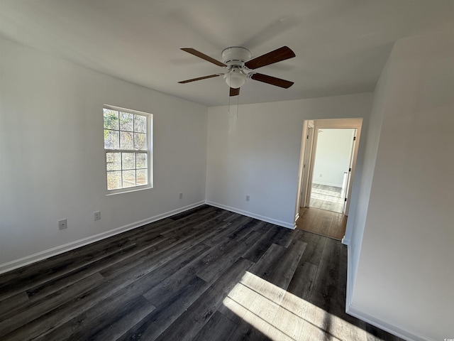 empty room with ceiling fan, baseboards, and dark wood finished floors