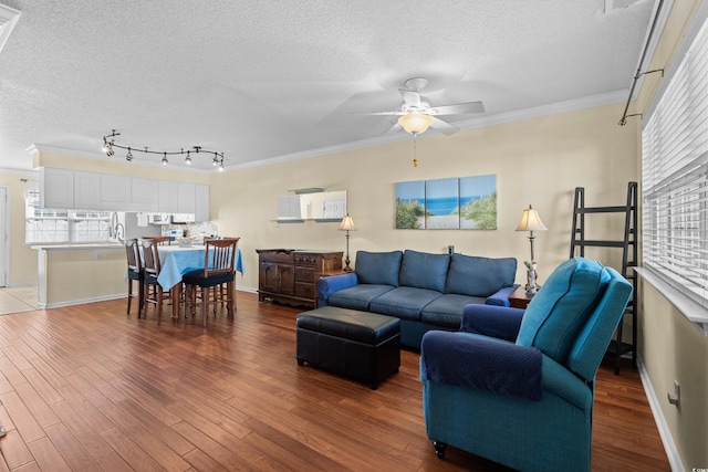 618 3rd Ave S Unit 4D, North Myrtle Beach, SC 29582 - living room with a textured ceiling, a ceiling fan, ornamental molding, wood finished floors, and baseboards