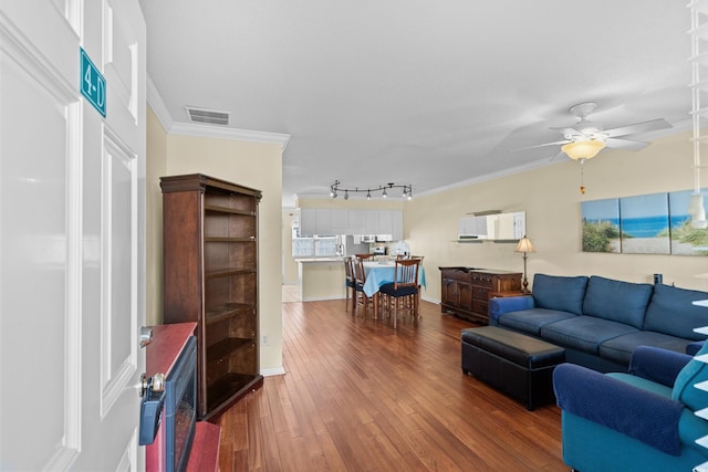 618 3rd Ave S Unit 4D, North Myrtle Beach, SC 29582 - living area with a ceiling fan, wood finished floors, crown molding, and healthy amount of natural light