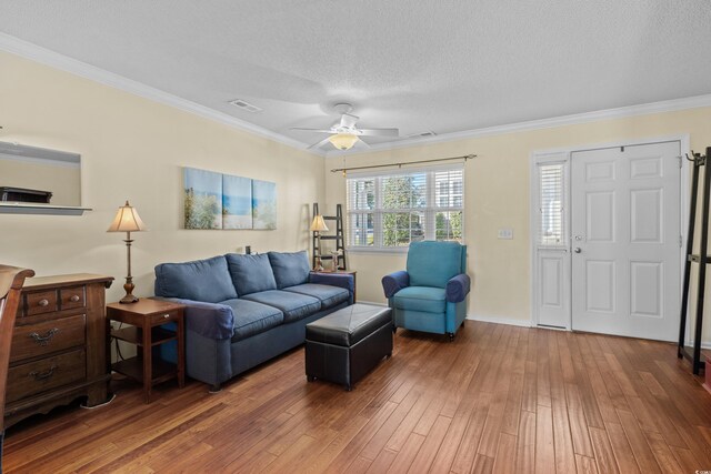618 3rd Ave S Unit 4D, North Myrtle Beach, SC 29582 - living area featuring hardwood / wood-style flooring, a textured ceiling, crown molding, a ceiling fan, and baseboards