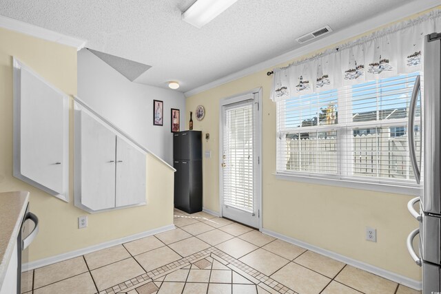 618 3rd Ave S Unit 4D, North Myrtle Beach, SC 29582 - entrance foyer with light tile patterned floors, a textured ceiling, and baseboards