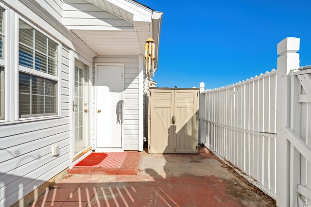 618 3rd Ave S Unit 4D, North Myrtle Beach, SC 29582 - view of patio with a shed, a fenced backyard, and an outdoor structure