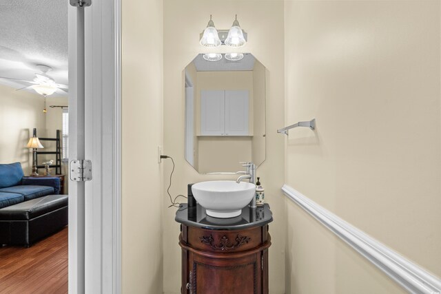 618 3rd Ave S Unit 4D, North Myrtle Beach, SC 29582 - bathroom featuring a ceiling fan, a textured ceiling, wood finished floors, and vanity