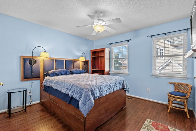 618 3rd Ave S Unit 4D, North Myrtle Beach, SC 29582 - bedroom with wood finished floors, baseboards, a textured ceiling, and a ceiling fan