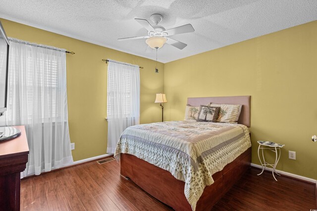 618 3rd Ave S Unit 4D, North Myrtle Beach, SC 29582 - bedroom featuring wood finished floors, a textured ceiling, baseboards, and a ceiling fan