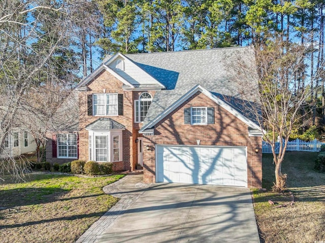 view of front of home with a garage and a front lawn