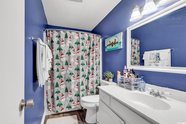 bathroom featuring a textured ceiling, vanity, toilet, a shower with shower curtain, and hardwood / wood-style flooring