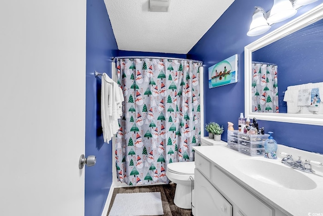 bathroom with toilet, vanity, wood-type flooring, a shower with curtain, and a textured ceiling
