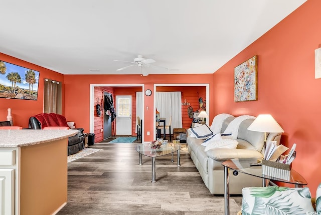 living room featuring ceiling fan and hardwood / wood-style flooring