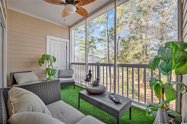 sunroom / solarium featuring ceiling fan