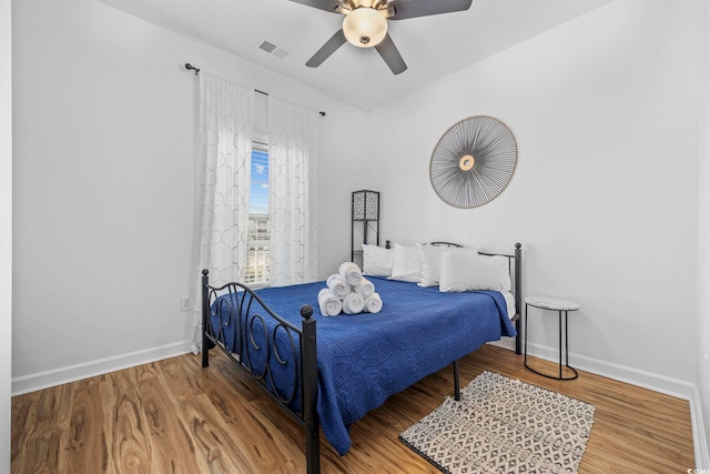 bedroom with ceiling fan and hardwood / wood-style floors