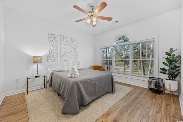 bedroom featuring ceiling fan and wood-type flooring