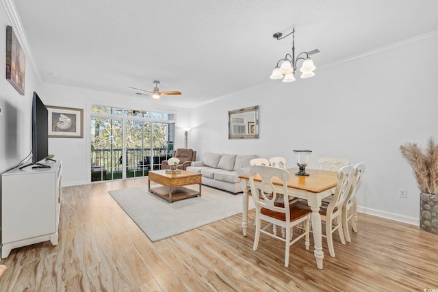 dining space with ceiling fan with notable chandelier, light hardwood / wood-style floors, and crown molding