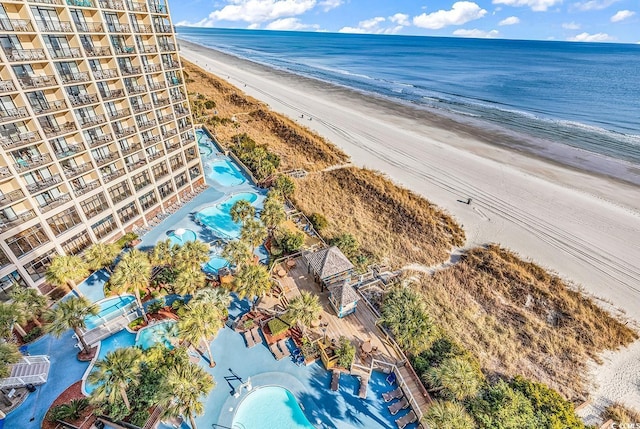 birds eye view of property with a water view and a view of the beach