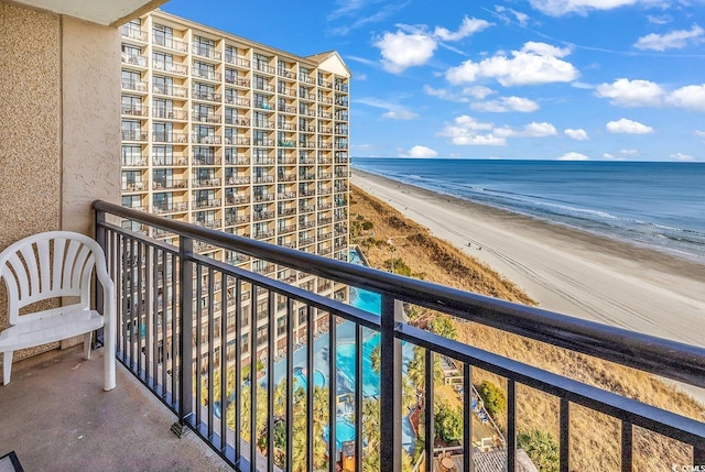 balcony with a water view and a beach view