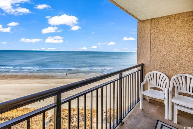 balcony with a beach view and a water view