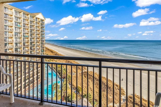 balcony featuring a view of the beach and a water view