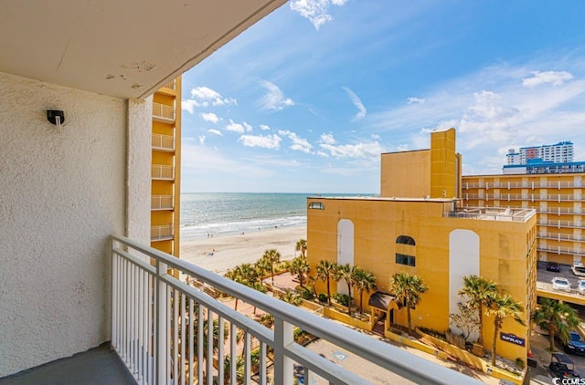 balcony featuring a water view and a beach view