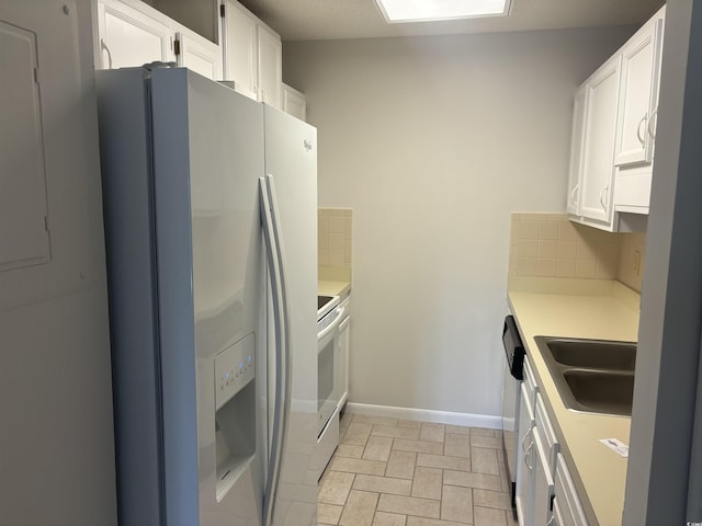 kitchen featuring white cabinets, white appliances, tasteful backsplash, and light countertops