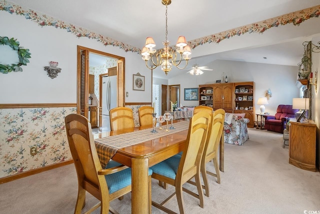 dining space featuring lofted ceiling, light colored carpet, baseboards, and wallpapered walls