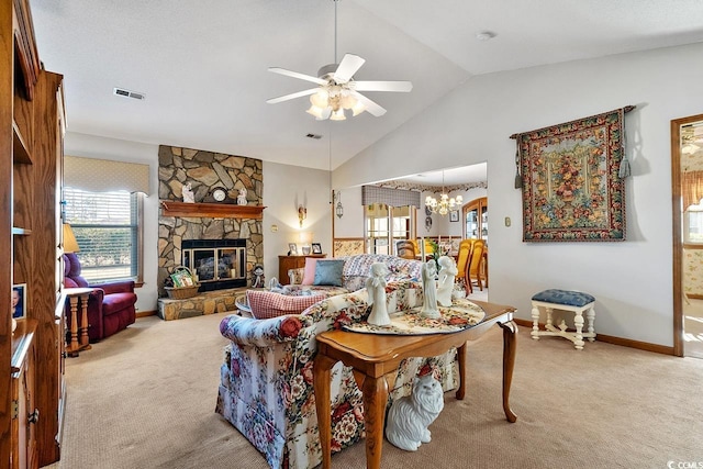 carpeted living room featuring plenty of natural light, visible vents, vaulted ceiling, and a stone fireplace