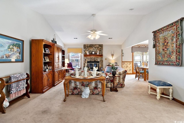 office with high vaulted ceiling, light colored carpet, ceiling fan, and a stone fireplace