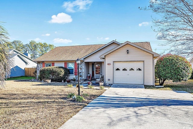 ranch-style home with a garage, driveway, and fence