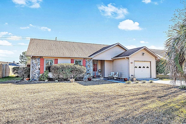 view of front of property with an attached garage, roof with shingles, concrete driveway, and a front yard