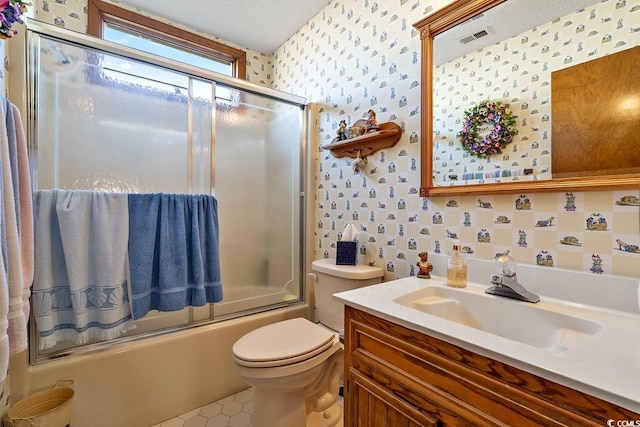 full bathroom with toilet, vanity, visible vents, combined bath / shower with glass door, and wallpapered walls