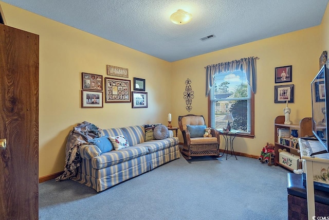 living area featuring a textured ceiling, carpet floors, visible vents, and baseboards