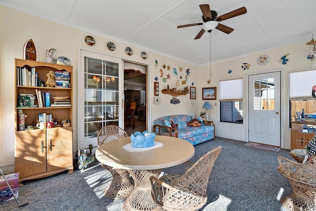 dining room featuring carpet flooring, a ceiling fan, and crown molding