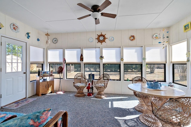 sunroom featuring ceiling fan