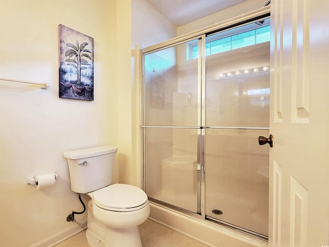 bathroom featuring toilet and an enclosed shower