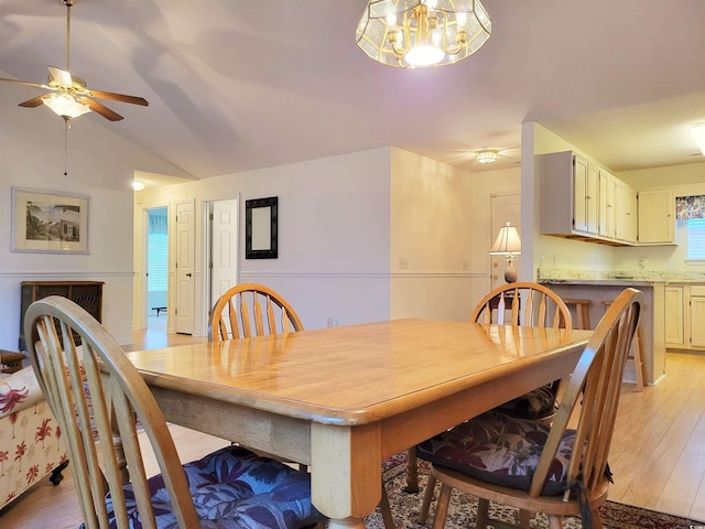 dining room featuring ceiling fan, light hardwood / wood-style flooring, and lofted ceiling