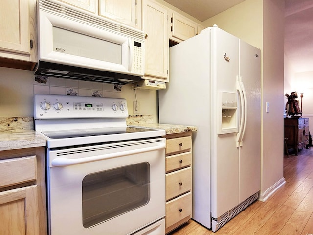 kitchen with light hardwood / wood-style floors and white appliances