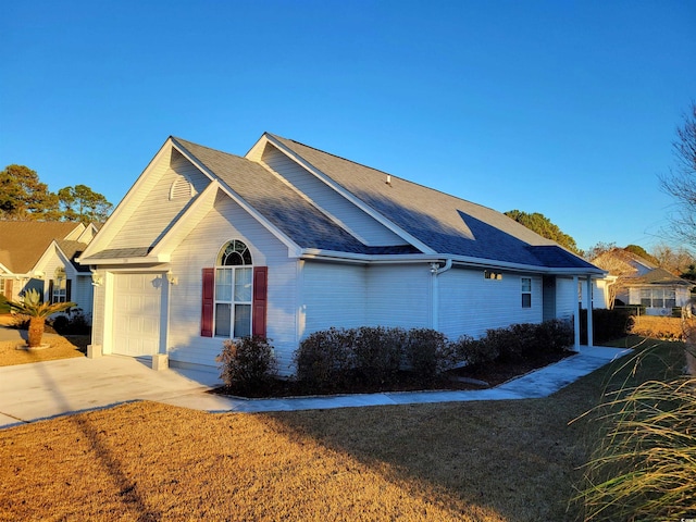 view of home's exterior featuring a yard and a garage