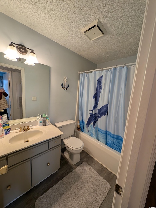 full bathroom featuring shower / tub combo, a textured ceiling, and hardwood / wood-style flooring