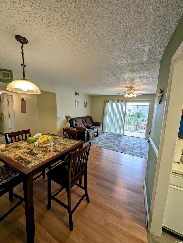 dining room with ceiling fan and light hardwood / wood-style flooring