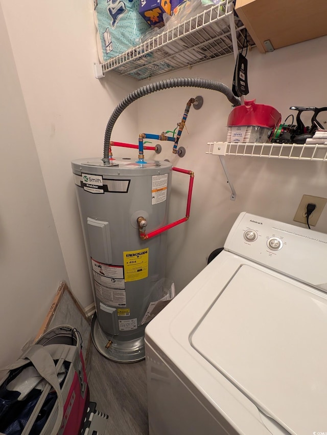 laundry room with wood-type flooring, water heater, and washer / clothes dryer