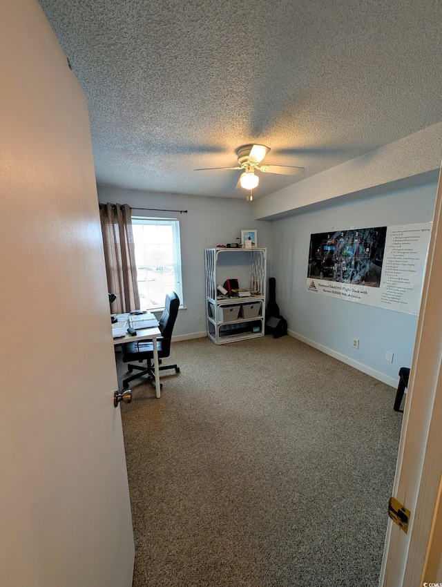 carpeted office featuring ceiling fan