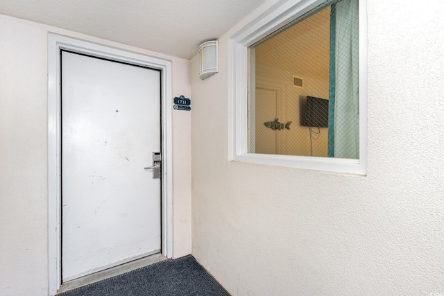 doorway to property with visible vents